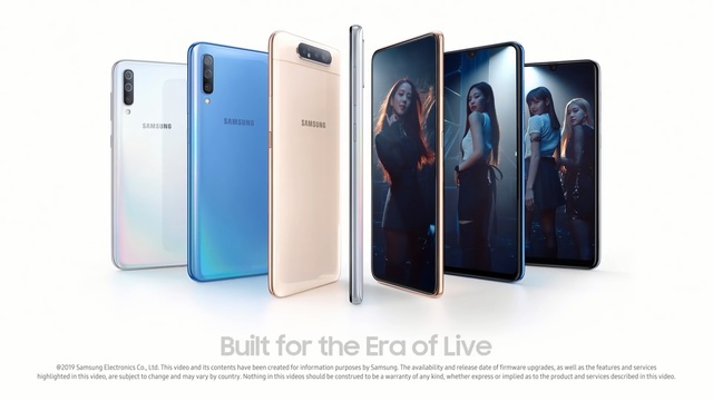 Video Reference: Gadget, Mobile phone, Product, Communication device, Electronic device, Technology, Smartphone, Portable communications device, Material property, Iphone, Sitting, Photo, Different, Computer, Monitor, Table, Small, Room, Group, Bunch, Desk, Standing, Display, Holding, White, Text, Telephone, Screenshot