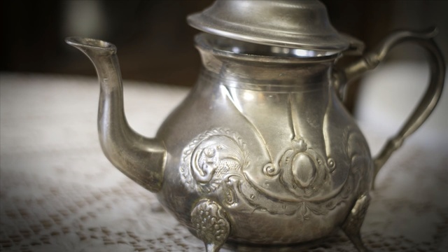 Video Reference: teapot, tableware, pitcher, jug, metal, silver, serveware, drinkware, kettle, brass, Person