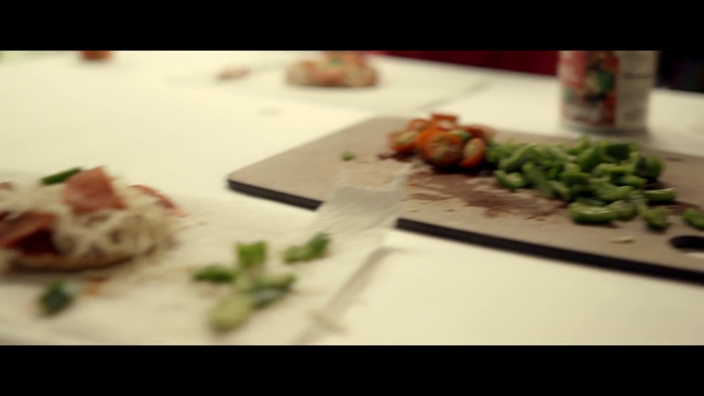 Video Reference: Dish, Food, Cuisine, Meal, À la carte food, Comfort food, Ingredient, Recipe, Sushi, Side dish, Indoor, Table, Plate, Sitting, Cutting, Pizza, Laptop, Piece, Slice, Board, White, Computer, Topped, Small, Knife, Fork, Cake, Desk, Wine, Salad, Cut, Laying, Cheese, Sandwich, Broccoli, Fast food, Tableware