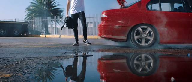 Video Reference: car, red, motor vehicle, vehicle, wheel, automotive design, automotive wheel system, family car, automotive tire, automotive exterior, Person