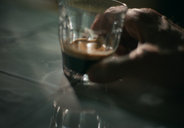 Video Reference: Glass, Drink, Hand, Water, Drinkware, Alcohol, Finger, Darkness, Wine glass, Stemware, Indoor, Table, Cup, Sitting, Food, Glasses, Cat, Black, Close, Cake, Plate, Coffee, Clear, White, Tableware, Wine, Transparent material, Fluid