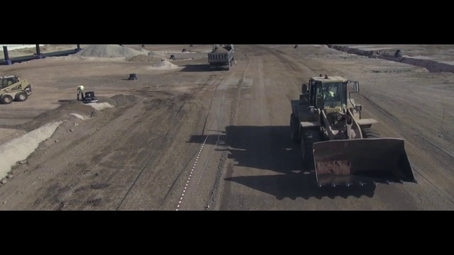 Video Reference: Asphalt, Mode of transport, Soil, Vehicle, Road surface, Road, Bulldozer, Tree, Photography, Sand