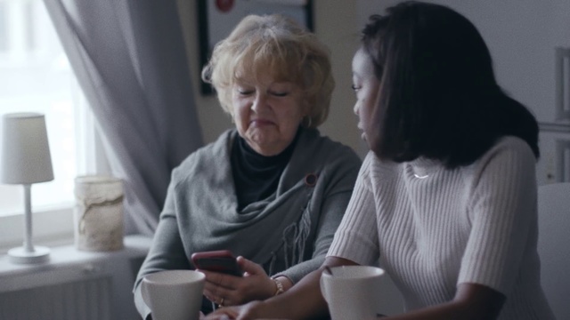 Video Reference: Conversation, Interaction, Fun, Technology, Electronic device, Sitting, Cup, Reading, Gadget, Grandparent, Person