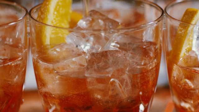 Video Reference: drink, old fashioned, cocktail, non alcoholic beverage, negroni, spritz, punch, orange drink, iced tea, mai tai, Person