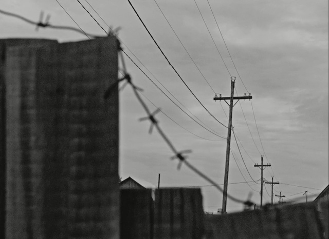 Video Reference: sky, black and white, overhead power line, cloud, electricity, electrical supply, monochrome photography, architecture, monochrome, building, Person