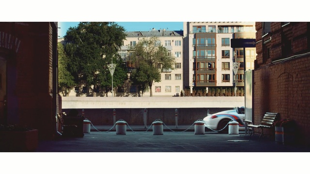 Video Reference: town, infrastructure, architecture, street, neighbourhood, facade, road, building, window, city, Person