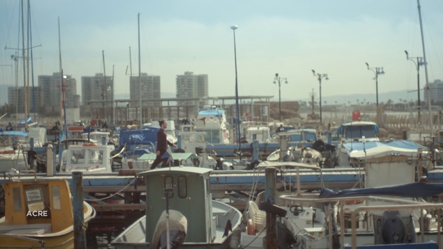 Video Reference: Marina, Urban area, Harbor, City, Metropolitan area, Port, Dock, Boat, Vehicle, Skyline, Person