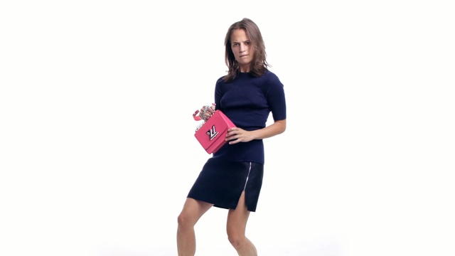 Video Reference: Shoulder, Clothing, Arm, Joint, Standing, Pink, Fashion, Sleeve, Neck, T-shirt, Person