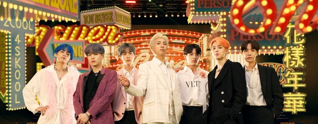 Video Reference: People, Snapshot, Event, Fun, Temple, Ceremony, Leisure, Happy, Smile, Person, Standing, Group, Man, Photo, Posing, Woman, Cake, Dressed, Large, Wearing, Food, Uniform, Store, Team, Table, Holding, Young, Street, Court, White, Clothing, Human face, Dancer