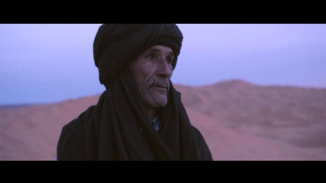 Video Reference: Photograph, Natural environment, Head, Desert, Human, Landscape, Screenshot, Aeolian landform, Ecoregion, Headgear