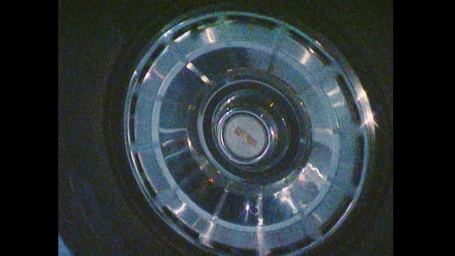 Video Reference: Circle, Wheel, Auto part, Automotive wheel system, Glass, Hubcap, Tire care, Rim, Indoor, Sitting, Plastic, Small, Table, Hand, Holding, Close, Orange, Standing, Phone, White, Blender, Silver, Old, Clear, Red, Display, Spiral