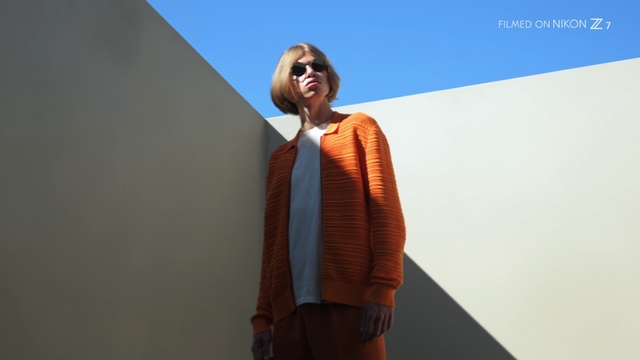 Video Reference: Clothing, Orange, Fashion, Outerwear, Brown, Eyewear, Shoulder, Street fashion, Sunglasses, Neck