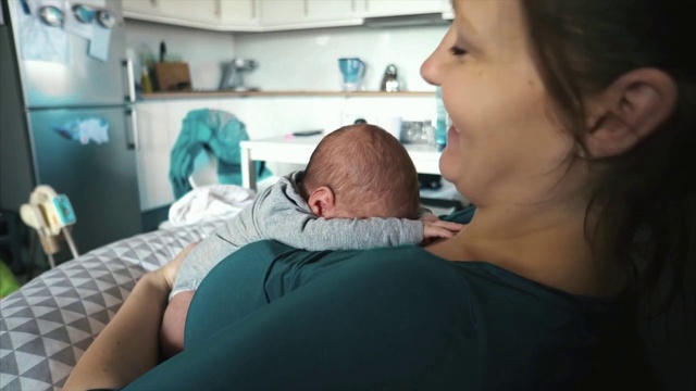 Video Reference: Child, Baby, Skin, Childbirth, Birth, Nose, Cheek, Patient, Hospital, Mouth, Person, Indoor, Woman, Sitting, Holding, Looking, Young, Girl, Smiling, Table, Room, Computer, Laptop, Eating, Green, Bed, Glasses, Teeth, Phone, Kitchen, Remote, Brushing, Man, Living, Playing, Video, Human face, Toddler, Clothing, Comfort