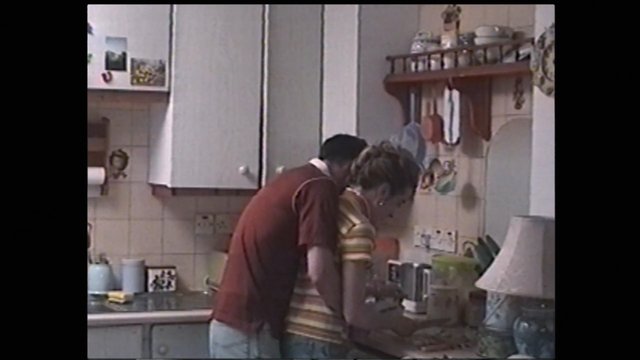 Video Reference: kitchen, home interior, cooking, people, countertop, cabinet, sink, appliances, indoor, domestic, family, vintage video, preparation, meal, home