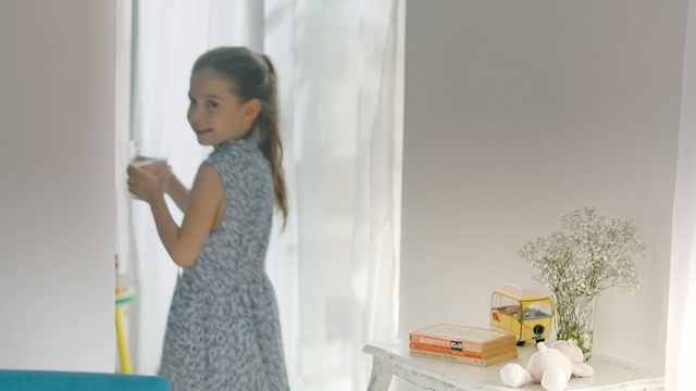 Video Reference: Child, Yellow, Room, Interior design, Toddler, Curtain, Floor, Window, Furniture, Person