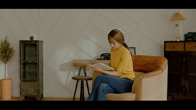 Video Reference: furniture, sitting, room, table, girl, shoulder, standing, human body, chair, house, Person