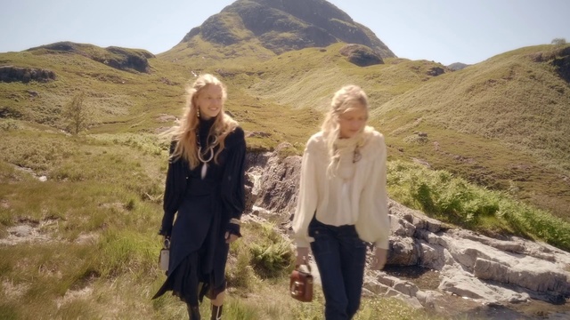 Video Reference: Mountainous landforms, Wilderness, Highland, Badlands, Mountain, Fell, Ecoregion, Hill, Geology, Mountain range, Outdoor, Grass, Nature, Person, Rock, Woman, Standing, Posing, Smiling, Young, Man, Girl, Desert, Holding, Field, Wearing, White, Green, Rocky, Country, Snow, Tall, Sky, Clothing, Hiking, Smile, Jacket, Footwear, Hillside