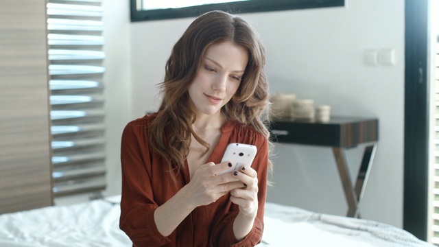 Video Reference: Product, Skin, Beauty, Shoulder, Lip, Electronic device, Neck, Brown hair, Outerwear, Technology