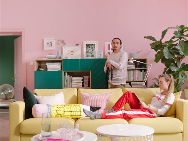 Video Reference: Pink, Living room, Furniture, Room, Yellow, Couch, Interior design, Table, Coffee table, Home, Person