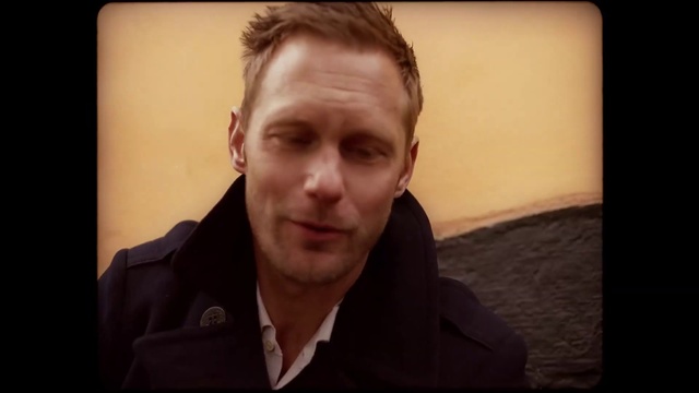 Video Reference: Face, Hair, Forehead, Cheek, Nose, Photograph, Chin, Facial hair, Facial expression, Eyebrow, Person, Man, Indoor, Suit, Looking, Front, Sitting, Shirt, Holding, Wearing, Laptop, Standing, Screen, Table, Monitor, Young, Computer, Black, Sign, Glasses, White, Phone, Wall, Human face, Clothing, Portrait