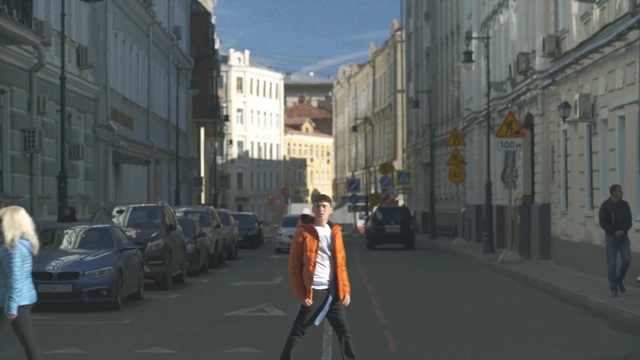 Video Reference: Mode of transport, Lane, Street, Town, Road, Neighbourhood, Pedestrian, Urban area, Snapshot, Human settlement, Person