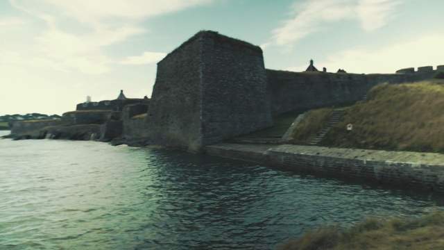 Video Reference: waterway, fortification, promontory, historic site, moat, castle, building, reservoir, sky, coast