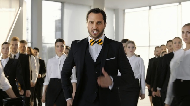 Video Reference: Suit, Formal wear, Event, White-collar worker, Gentleman, Fashion, Male, Tuxedo, Businessperson, Room