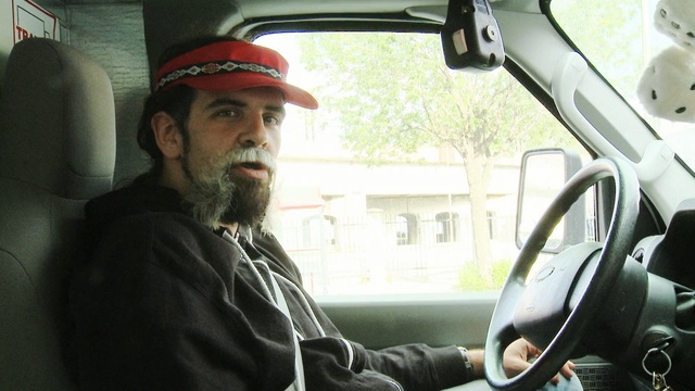 Video Reference: car, motor vehicle, vehicle, mode of transport, facial hair, automotive design, vehicle door, driving, beard, city car