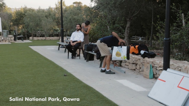 Video Reference: plant, vehicle, grass, recreation, tree, lawn, games, asphalt, outdoor structure, walkway, Person