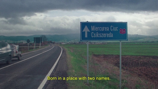 Video Reference: Road, Highway, Natural landscape, Signage, Street sign, Infrastructure, Lane, Land lot, Sign, Cloud