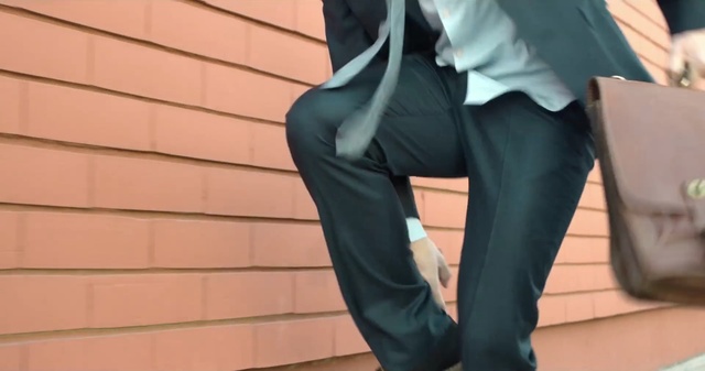Video Reference: leg, shoulder, suit, shoe, outerwear, joint, formal wear, girl, thigh, trousers, Person
