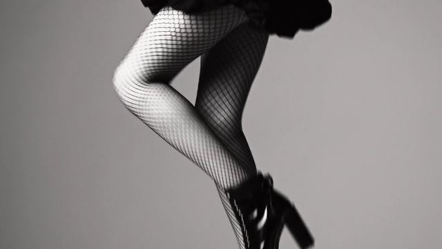Video Reference: Leg, Tights, Black, Human leg, Clothing, Stocking, Thigh, Black-and-white, Monochrome, Knee, Person, Indoor, Man, Holding, Young, Wearing, Video, Hand, Remote, Standing, Shirt, Air, Woman, Wii, Playing, White, Game, Doing, Room, Wall, High heels, Boot, Footwear, Arm