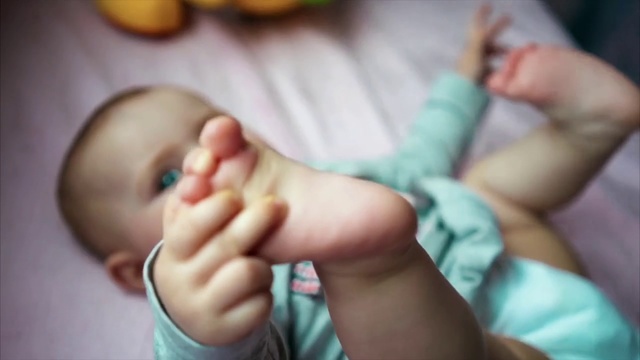 Video Reference: Child, Finger, Baby, Hand, Toe, Skin, Nail, Leg, Foot, Arm, Person, Indoor, Little, Girl, Young, Holding, Small, Sitting, Food, Eating, Boy, Toothbrush, Looking, Woman, Brush, Brushing, Toddler, Teeth, Mouth, Table, Hair, Donut, Shirt, Plate, Fruit, Cake, Remote, Playing, Pink, Bed