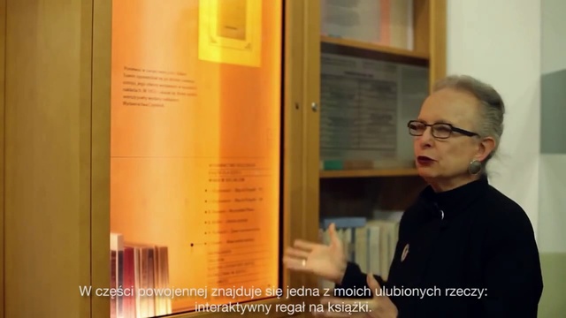 Video Reference: Poster, Room, Door, Wood, Public speaking, Interior design, Person