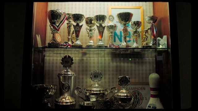 Video Reference: Display case, Collection, Display window, Glass, Shelf, Window, Furniture, Antique, Art, Interior design, Person