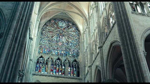 Video Reference: Stained glass, Gothic architecture, Architecture, Place of worship, Holy places, Byzantine architecture, Medieval architecture, Cathedral, Glass, Building, Large, Train, Clock, Front, People, Sitting, Standing, Church, City, Man, White, Track, Group, Window, Arcade, Arch, Altar