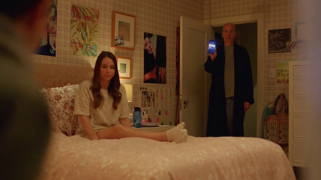 Video Reference: Bed, Bedroom, Room, Furniture, Bed sheet, Textile, Linens, Bedding, Comfort, Flesh, Person, Indoor, Photo, Sitting, Looking, Standing, Front, Man, Orange, Young, Girl, Woman, Holding, Mirror, White, Wall, Human face, Bathroom, Clothing, Bathtub