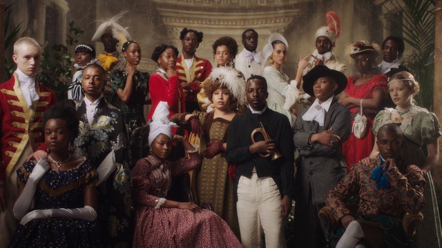 Video Reference: Event, Painting, Art, Person, Indoor, Posing, Photo, Group, Standing, Large, Holding, Man, Front, People, Woman, Crowd, Wine, Old, Wearing, Young, Room, Red, White, Train, Clothing, Smile, Human face