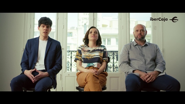 Video Reference: Sitting, Conversation, Adaptation, Event, Photography, White-collar worker, Happy, Gentleman, Person, Man, Window, People, Looking, Bench, Woman, Photo, Couple, Posing, Group, Standing, Holding, Different, Table, Train, Room, Clothing, Smile, Human face, Suit, Text, Glasses