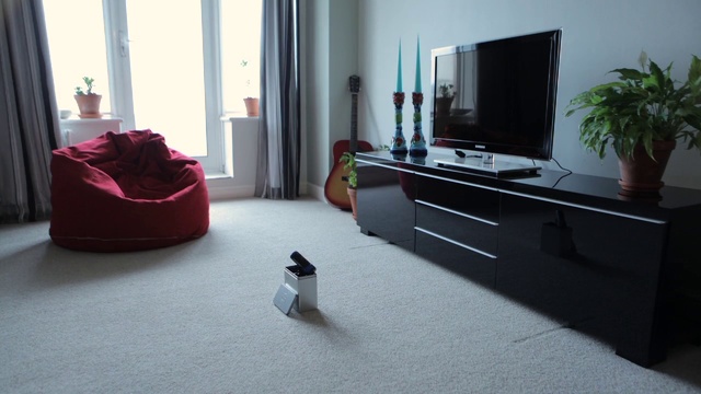 Video Reference: Room, Floor, Furniture, Interior design, Flooring, Living room, Chest of drawers, Material property, Table, Laminate flooring