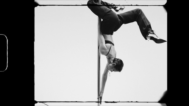 Video Reference: Dance, Pole dance, Black-and-white, Performing arts, Performance, Event, Acrobatics, Footwear, Leg, Athletic dance move