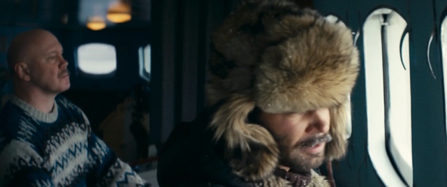 Video Reference: Fur clothing, Fur, Hair, Head, Fun, Textile, Cap, Human, Organ, Headgear, Person, Indoor, Sitting, Man, Looking, Front, Hat, Wearing, Table, Young, Holding, Standing, Black, Woman, White, Computer, Bed, Shirt, Room, Bus, Carnivore, Dog