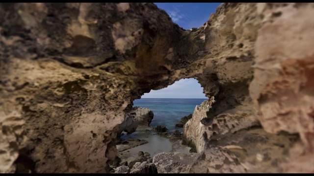 Video Reference: rock, formation, sky, terrain, natural arch, cliff, coastal and oceanic landforms, sea, coast, sea cave