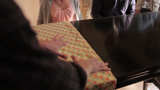 Video Reference: Hand, Room, Textile, Finger, Table, Flooring, Interior design, Furniture, Art