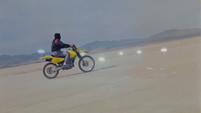 Video Reference: motorcycling, mode of transport, sand, motorcycle, racing, vehicle, landscape, adventure, stunt performer, road