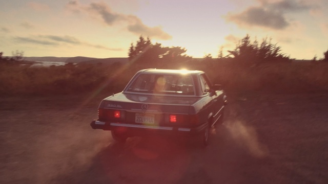 Video Reference: car, mode of transport, vehicle, sky, light, automotive design, automotive exterior, landscape, sunlight, driving, Person