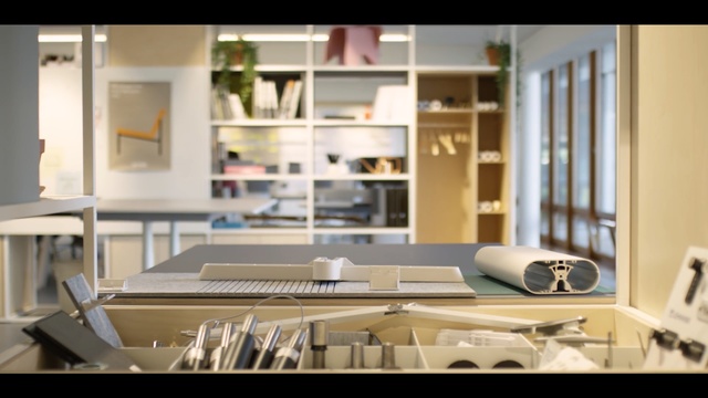 Video Reference: Room, Furniture, Interior design, Living room, Table, Architecture, Building, Shelf, Design, Material property, Person