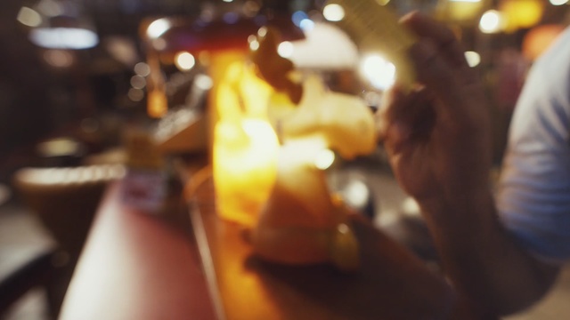Video Reference: yellow, drink, alcohol, hand, food, fun, Person