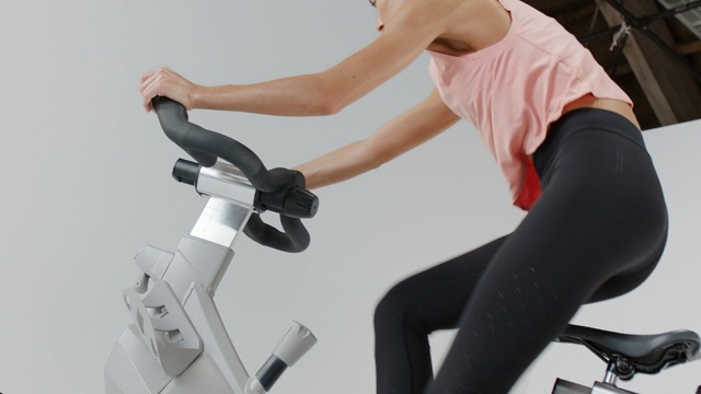 Video Reference: Stationary bicycle, Exercise equipment, Exercise machine, Indoor cycling, Exercise, Physical fitness, Arm, Sports equipment, Leg, Bicycle accessory