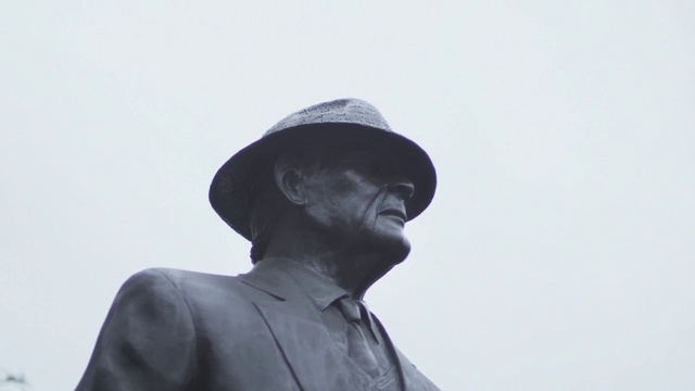 Video Reference: White, Head, Standing, Human, Headgear, Gentleman, Photography, Hat, Neck, Black-and-white